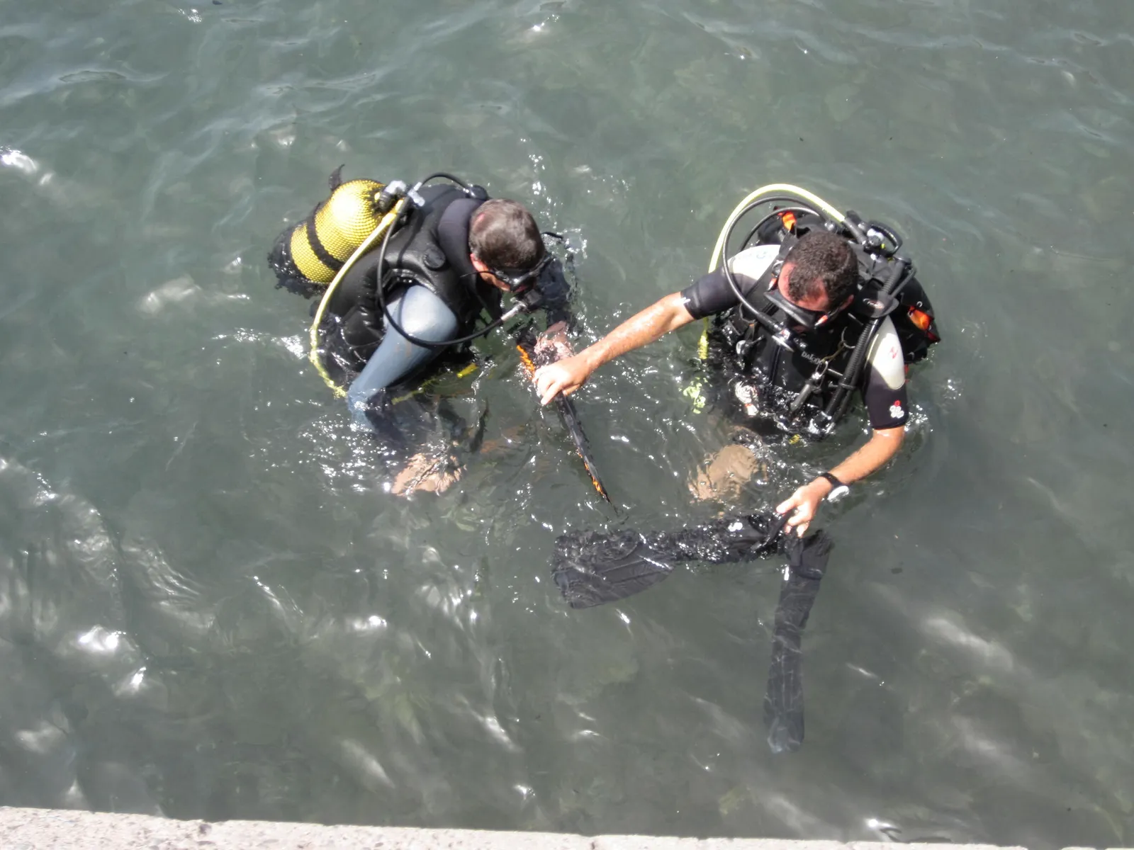 Two scuba divers at the surface preparing to descend, Madeira